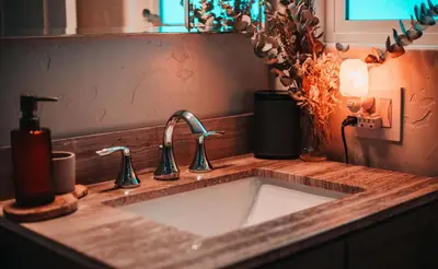 a kitchen sink with two faucets on a counter at Tahoe Trail Retreat - Steps from the TRT in Zephyr Cove