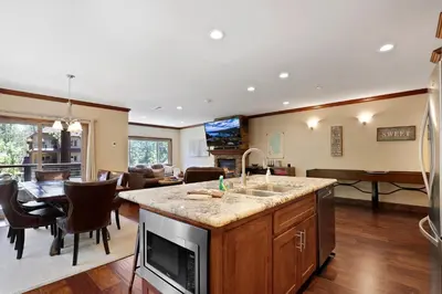a kitchen with a sink and a living room at Tahoe Woods Villa - Walk to Beach and Gondola - Heavenly Ski in South Lake Tahoe