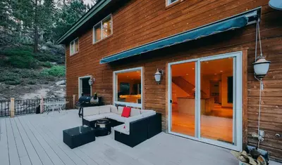 a house with a deck with a couch and a patio at The Elevator House - Sleeps 10 in Stateline