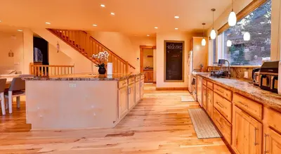 a large kitchen with wooden floors and a counter top at The Elevator House - Sleeps 10 in Stateline