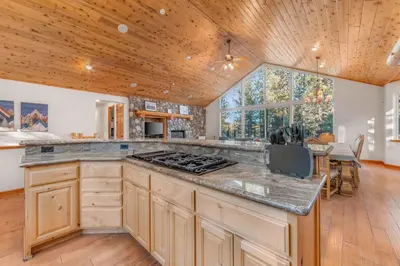 a kitchen with a stove top oven in a room at The Lodge on Oaxaco - Epic Man Cave with Billiard Room in South Lake Tahoe