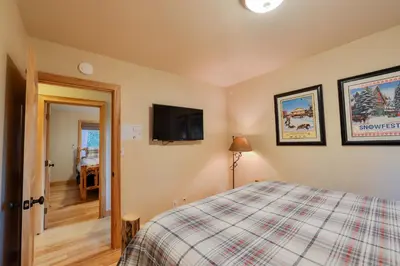a bedroom with a bed and a flat screen tv at The Meadows - Ski Lease - Extended 30 Plus Days in South Lake Tahoe