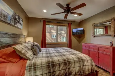 a bedroom with a bed and a ceiling fan at Willow's Hideaway - Pet Friendly Cozy Cabin in South Lake Tahoe