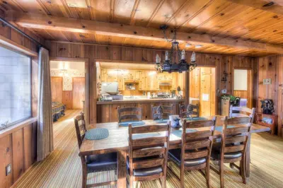 a dining room with a wooden table and chairs at Zephyr Cove Cabin - Walk to Lake & Beach in Zephyr Cove