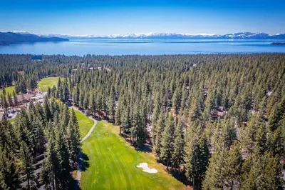 an aerial view of a golf course with trees and water at Canoe Cabin I Sleeps 8 I Hot Tub I Pet Friendly in Incline Village