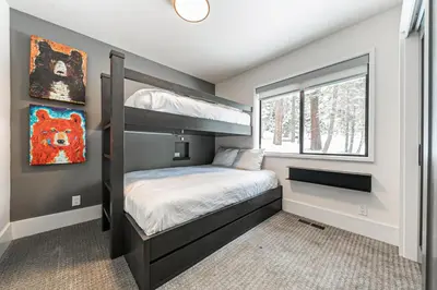 a bedroom with a bunk bed and a window at Misty Pines by Tahoe Getaways at Tahoe Park - Newly Remodeled Pet Friendly 3 BR w Private Beach HOA in Tahoe City