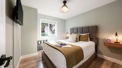 a bedroom with a large bed and a television at Geraldine Drive by AvantStay Hot Tub Views Walk to Trails Game Room in Incline Village