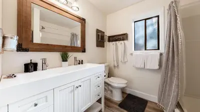 a white bathroom with a sink and a toilet at Geraldine Drive by AvantStay Hot Tub Views Walk to Trails Game Room in Incline Village