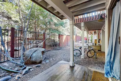 a house with a fence and a bike parked next to it at Family Friendly! Incline Village Condo with Foosball in Tyrolian Village