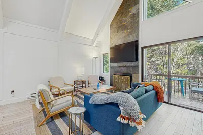 a living room with a blue couch and a fireplace at Family Friendly! Incline Village Condo with Foosball in Tyrolian Village