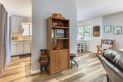 a living room with a teddy bear on a shelf at Peaceful Forest Views and Patio Twain Harte Home in Twain Harte