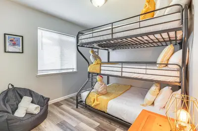 a bedroom with two bunk beds and a table at Peaceful Forest Views and Patio Twain Harte Home in Twain Harte