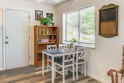 a dining room with a table and chairs and a window at Peaceful Forest Views and Patio Twain Harte Home in Twain Harte