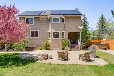 a home with a patio with chairs in the yard at 5 Mi to Northstar Resort! Family Home with Hot Tub in Truckee