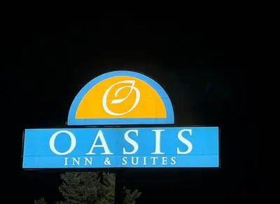 a sign for a nissin int and suites at Oasis Inn and Suites in Fallon