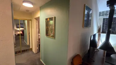 a hallway with green walls and a mirror at Eagle Summit Collection in Mammoth Lakes