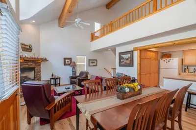 a kitchen and living room with a table and chairs at RR-Hideaway_Down_Cyn 104 in June Lake