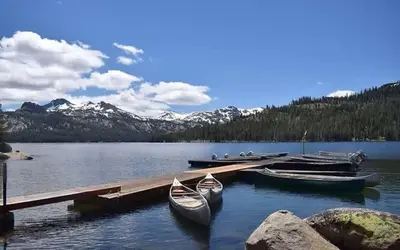 two boats are docked at a dock on a lake at Kirkwood Studio Full Kitchen & Meadow Balcony in Kirkwood