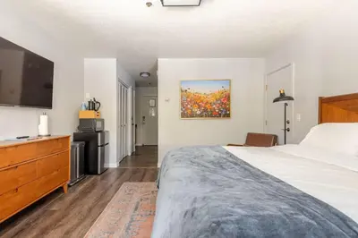 a bedroom with a bed and a painting on the wall at The Lookout Loft Great views and King Sized Bed in Kirkwood
