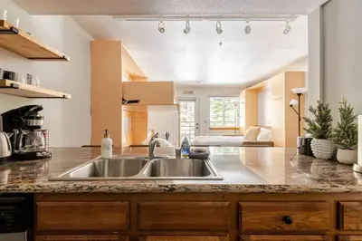 a kitchen with a sink and a counter top at Super-Efficient Studio with Full Kitchen Balcony & Smart Sleeping Options in Kirkwood