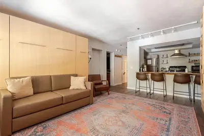 a living room with a couch and a kitchen at Modern Kirkwood One Bedroom with Deck in Kirkwood
