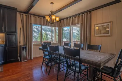 a dining room with a wooden table and chairs at RR-Villa Lago STR AP 18-003 in June Lake