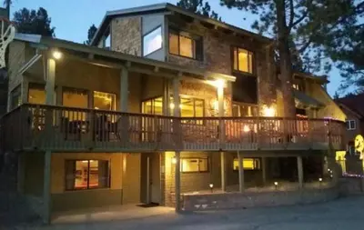 a large house with a large deck on top of it at RR-Villa Lago STR AP 18-003 in June Lake