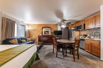 a room with a bed and a kitchen and a table at 113 Bldg B studio in Truckee