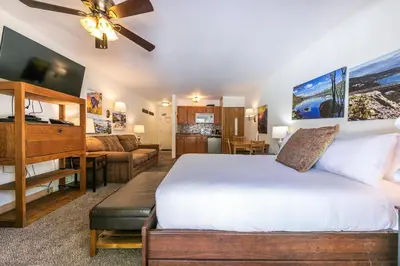a bedroom with a bed and a living room at 212 Bldg B condo in Truckee