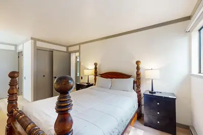 a bedroom with a large bed with a wooden frame at Mammoth Point 119 in Mammoth Lakes
