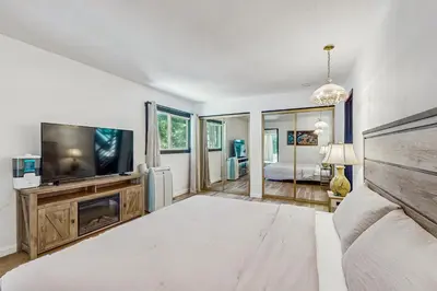 a bedroom with a bed and a flat screen tv at The Bunk and Birch Retreat in South Lake Tahoe