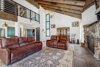 a living room with leather furniture and a fireplace at The Bunk and Birch Retreat in South Lake Tahoe