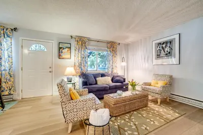 a living room with a blue couch and chairs at 1 Mi to Reno-Sparks Family Retreat with Fireplace! in Reno