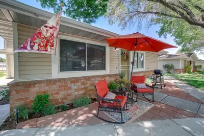a patio with two chairs and an umbrella at 1 Mi to Reno-Sparks Family Retreat with Fireplace! in Reno