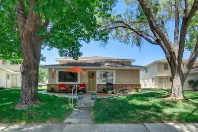 a house with an orange umbrella in the front yard at 1 Mi to Reno-Sparks Family Retreat with Fireplace! in Reno