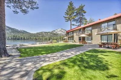 a building with a picnic table next to a lake at 146 Bldg C condo in Truckee