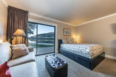 a bedroom with a bed and a couch and a window at 146 Bldg C condo in Truckee