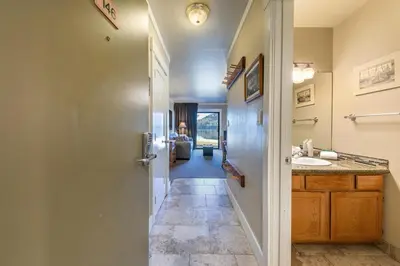 a hallway leading to a bathroom with a sink at 146 Bldg C condo in Truckee