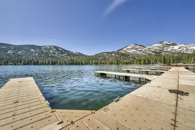 a dock on a lake with mountains in the background at 244 Bldg C condo in Truckee