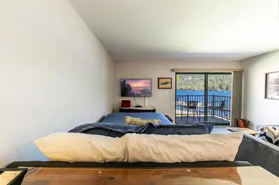 a bedroom with two beds and a balcony at 244 Bldg C condo in Truckee