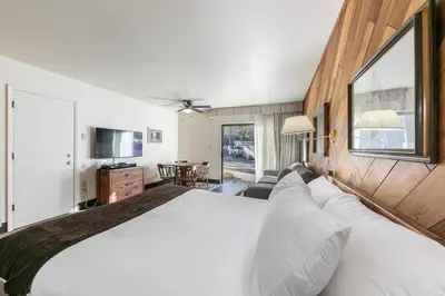 a bedroom with a large bed and a living room at 135 Bldg C condo in Truckee