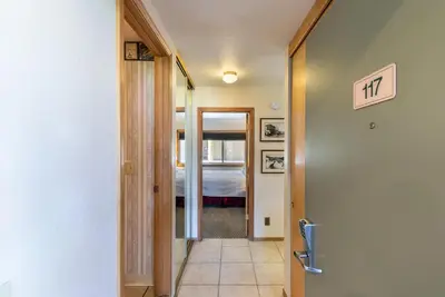 a hallway with a door leading to a bedroom at 117 Bldg B condo in Truckee
