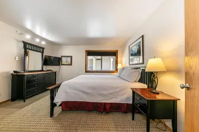 a bedroom with a bed and a desk and a television at 117 Bldg B condo in Truckee