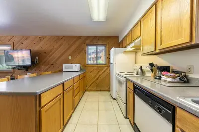 a kitchen with wooden cabinets and a white refrigerator at 117 Bldg B condo in Truckee