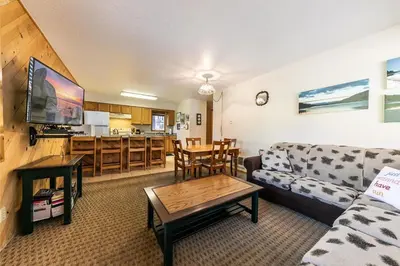 a living room with a couch and a table at 117 Bldg B condo in Truckee