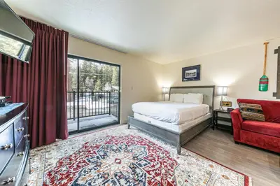 a bedroom with a bed and a red couch at 233 Bldg C condo in Truckee