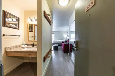 a hallway with a bathroom with a sink and a door at 233 Bldg C condo in Truckee