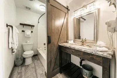 a bathroom with a sink and a toilet and a mirror at 231 Bldg C condo in Truckee