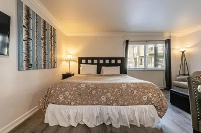 a bedroom with a bed and a chair and a window at 115 Bldg B studio in Truckee