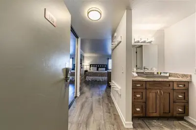 a hallway leading to a bedroom with a bed at 115 Bldg B studio in Truckee